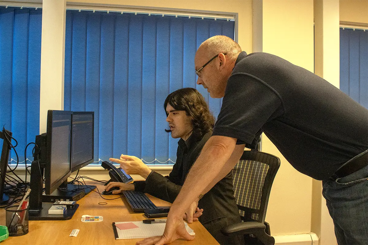 MT Service employees working on a computer helping with cyber security issues